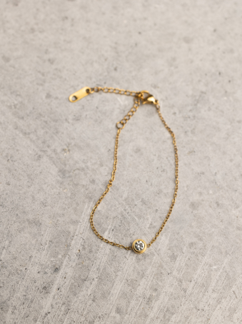Pulsera fina dorada con zirconia central