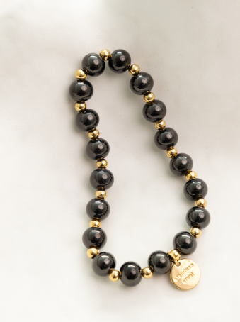 Pulsera elástica con cuentas negras y doradas en acero inoxidable 316