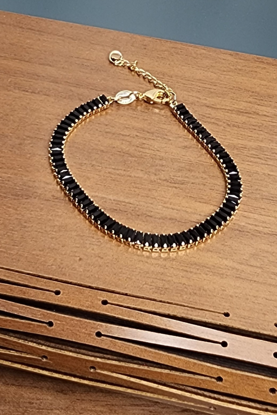 Gold bracelets with black stones